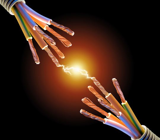 Two bundles of multicoloured electrical wires with a bright spark jumping between the bare copper ends against a black background