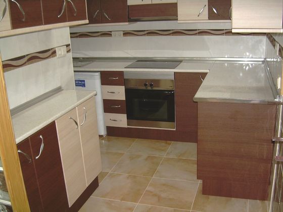 A kitchen with gloss units